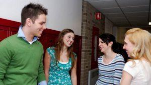 Teens standing in a school hallway
