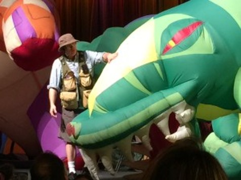 Man with a blow-up dinosaur