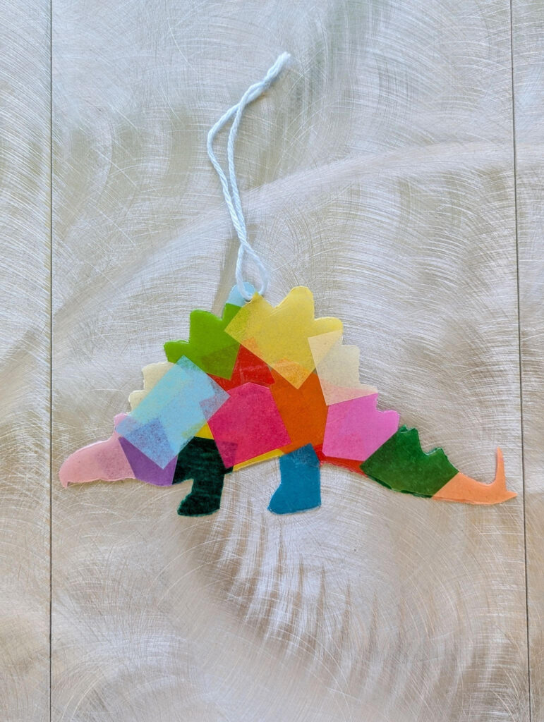 This Week in the Children's Department 1 stegosaurus suncatcher with colorful tissue paper